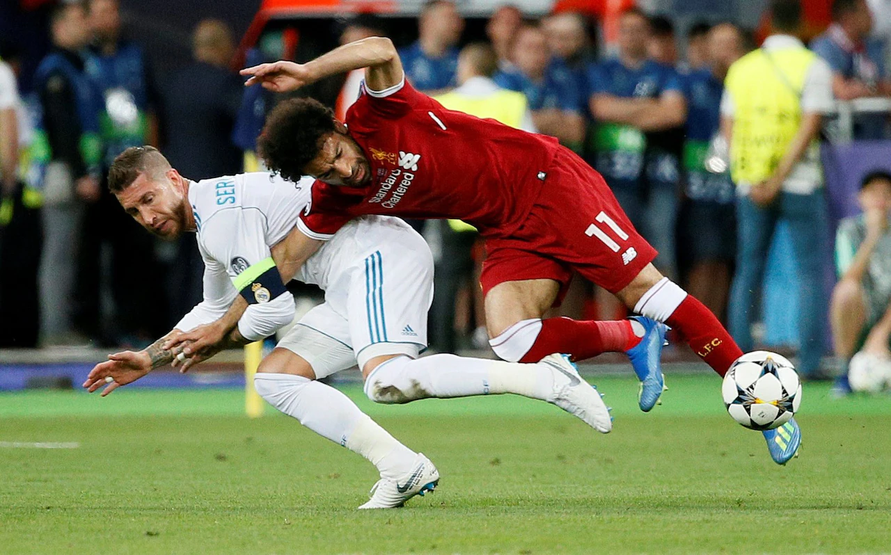 An image illustration of Sergio Ramos making a tactical tackle against Salah